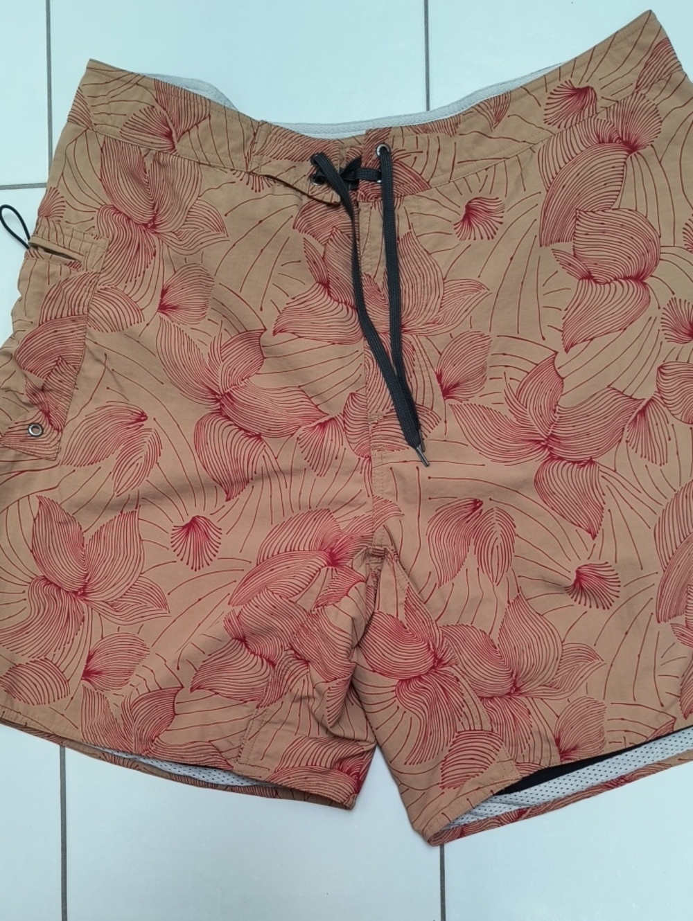 Tan Patagonia board shorts with red abstract pattern, waist size - 38